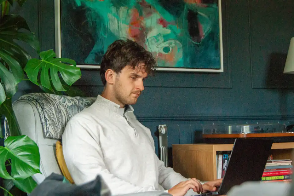Ben Miller working at his laptop